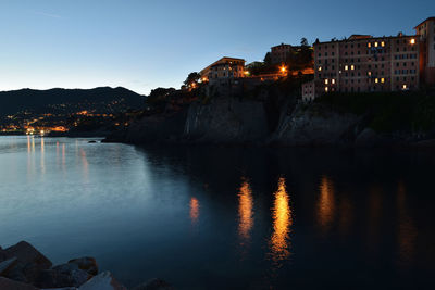 Reflection of illuminated buildings in lake at night