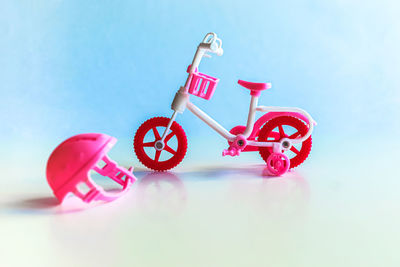 Close-up of pink toy bicycle against sky