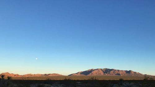 Scenic view of mountains against clear blue sky