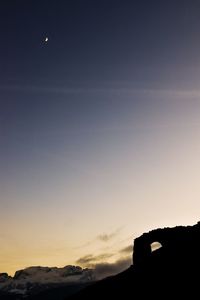 Silhouette of building against sky during sunset