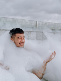 Portrait of young woman swimming in bathtub