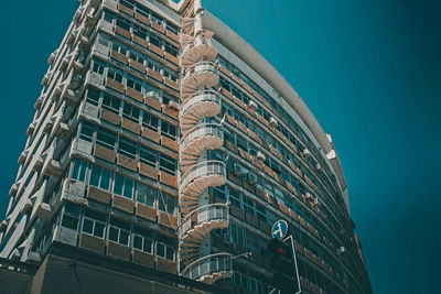 Low angle view of modern building against clear blue sky