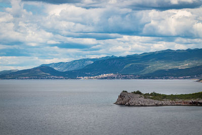 Scenic view of sea and mountains against sky