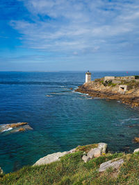 Scenic view of sea and lighthouse against sky in brittany 