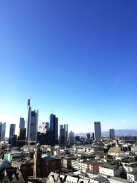 View of cityscape against blue sky