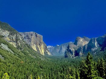 Scenic view of mountains against clear blue sky