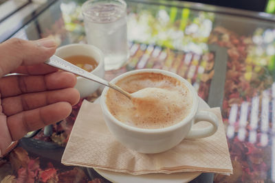 Midsection of coffee cup on table