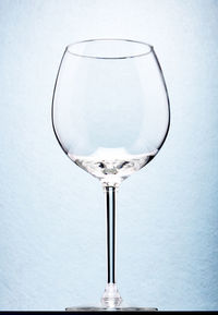 Close-up of wineglass against white background