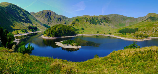 Scenic view of lake and mountains against sky