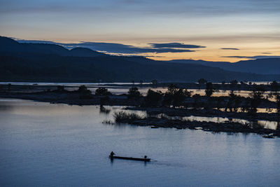 Scenic view of lake against sky during sunset