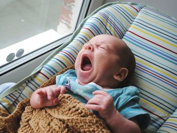 High angle view of baby boy sleeping on bed