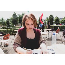 Portrait of woman sitting on table