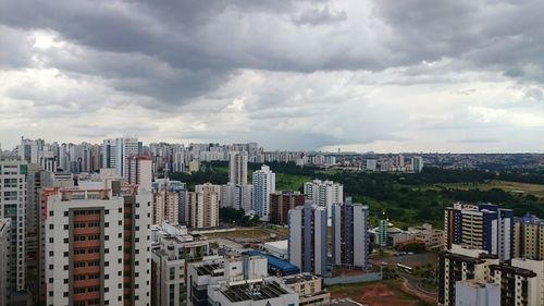 Skyscrapers against cloudy sky