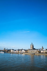 Distant view of cologne cathedral against blue sky