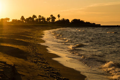 Scenic view of beach against sky during sunset