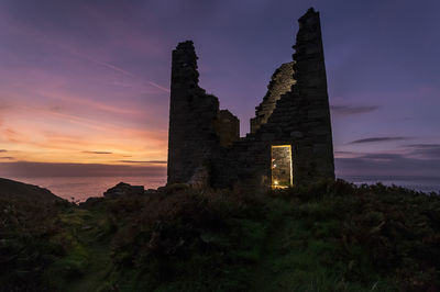 Castle against sky at sunset