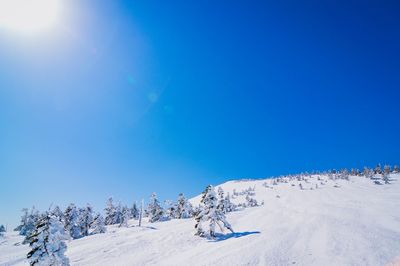 Scenic view of snowcapped mountains against clear blue sky