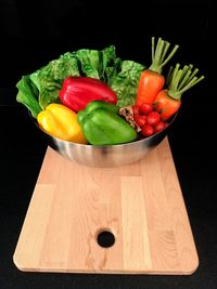 High angle view of vegetables on table against black background