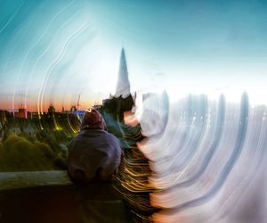 Digital composite image of fountain against lake