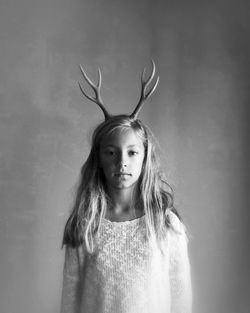 Portrait of young girl with antlers