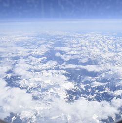 Aerial view of snowcapped mountains against sky