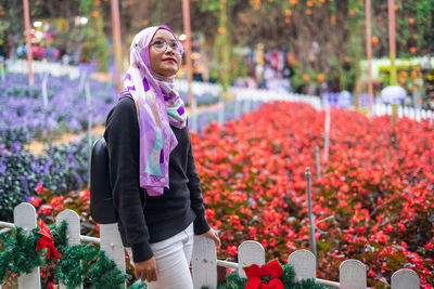 Woman standing on flowering plants