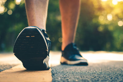 Low section of man wearing shoe