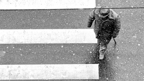 Low section of person walking on road