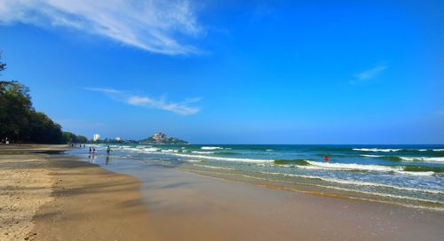 Scenic view of beach against blue sky