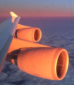 Close-up of orange car against sky during sunset