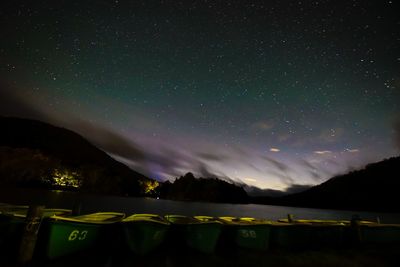 Scenic view of illuminated mountains against sky at night