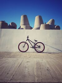 Bicycles on beach against clear sky