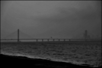 View of suspension bridge over sea