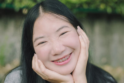 Close-up portrait of smiling young woman