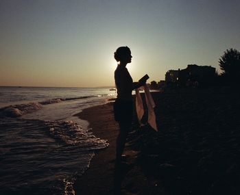 Side view of woman standing on beach