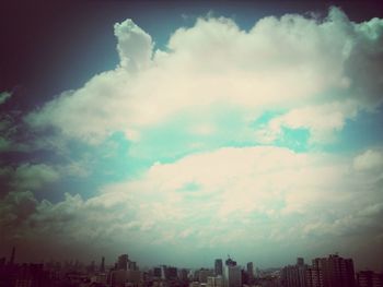 Cityscape against cloudy sky