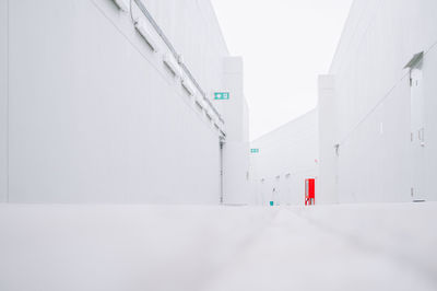 White building against clear sky during winter