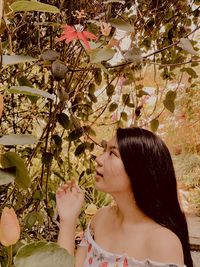 Woman looking at plants in park