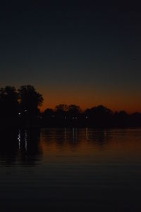 Scenic view of lake against sky at sunset