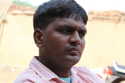 Close-up portrait of young man looking away