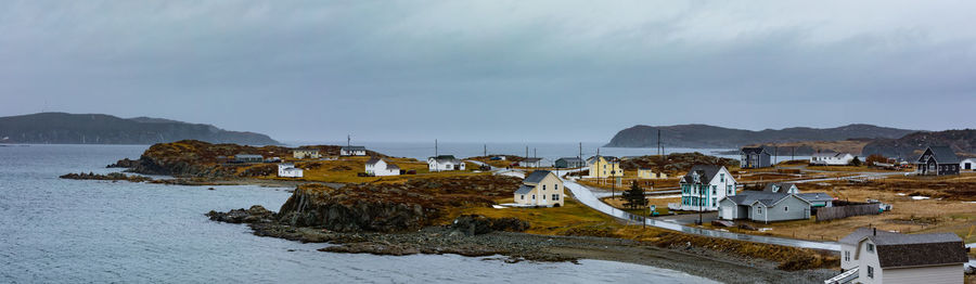 Scenic view of sea and buildings against sky