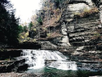 Full frame shot of water flowing through rocks in forest