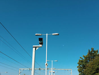 Low angle view of street light against clear blue sky