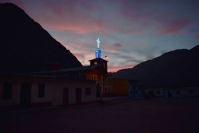 Silhouette buildings against sky at sunset