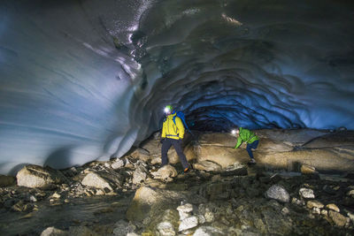 Adventurous couple exploring ice cave near vancouver.