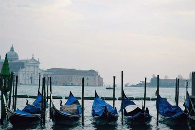 Boats moored in sea against sky