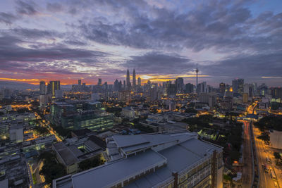 Illuminated cityscape against sky