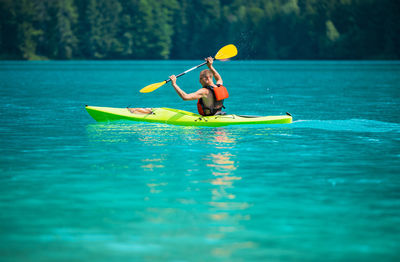 Man kayaking in sea