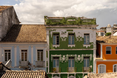 Houses in town against sky