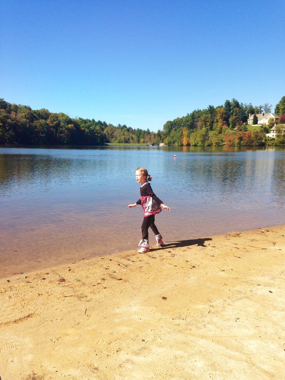 water, full length, lifestyles, leisure activity, clear sky, casual clothing, lake, childhood, tranquility, tranquil scene, boys, rear view, person, standing, nature, tree, beauty in nature, scenics